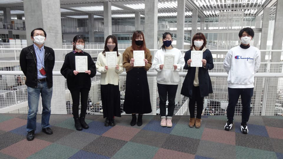 最優秀チームメンバ(中5人)と運営代表学生(右端)、運営教員(左端)のイメージ